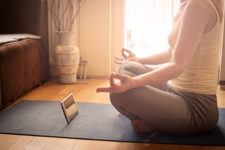 Unrecognizable Woman With Digital Tablet Using Meditation App In Bedroom .